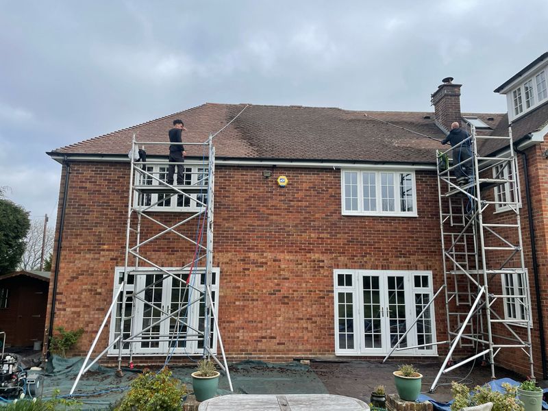 Roof cleaning carried out safely from scaffold towers by The Roof Moss Cleaners in Bagshot